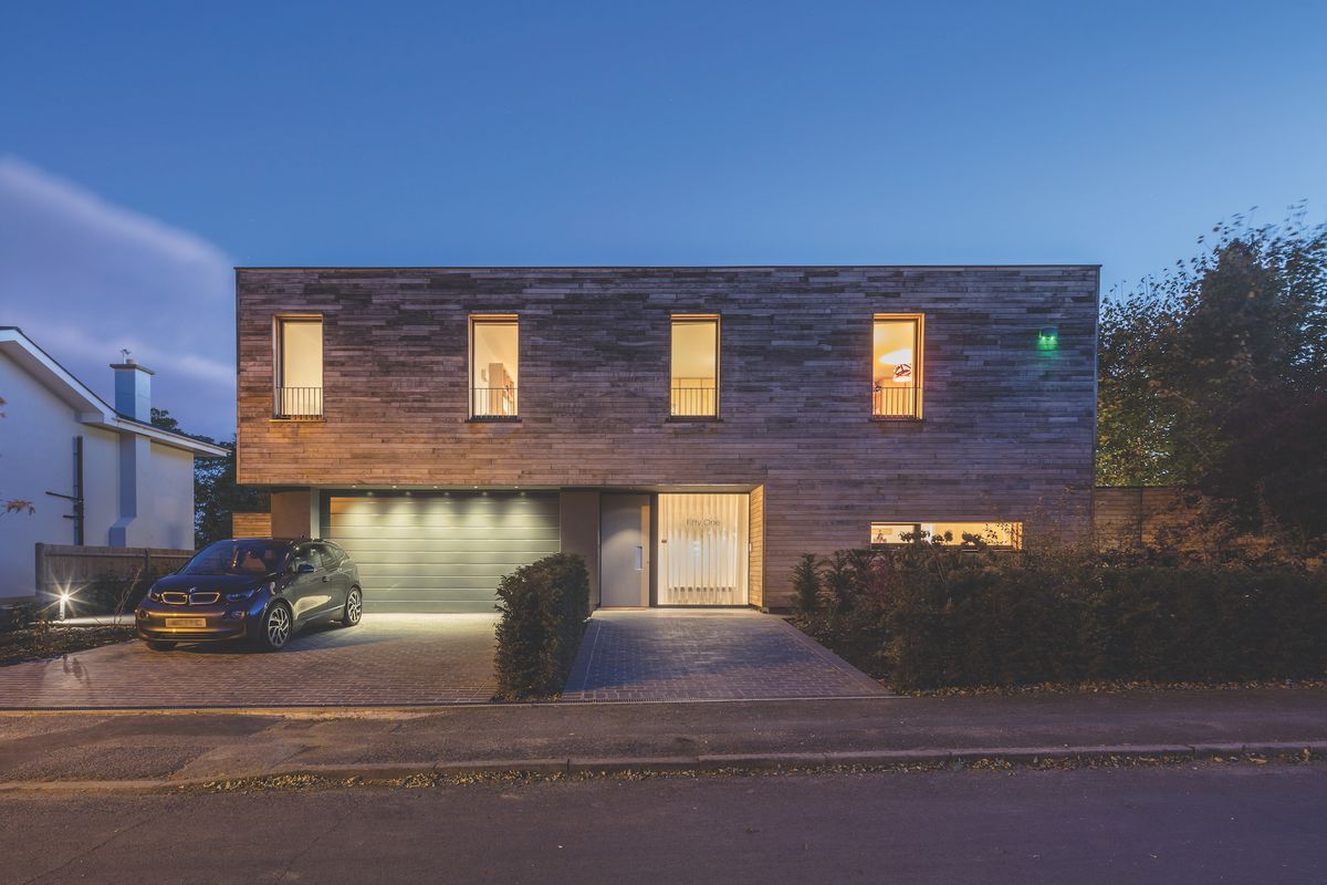timber cladding on exterior front of self build with drive