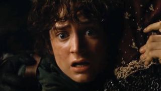 Frodo is held back while Gandalf clings onto the edge of a cliff. 