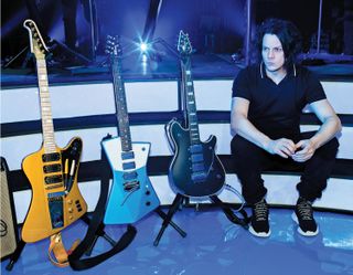 Jack White with his three main current touring guitars, all of which were tweaked for or by White: (from left) a Gibson Jeff “Skunk” Baxter Fort Knox Firebird with a maple neck, an Ernie Ball Music Man St. Vincent signature model with blue aluminum Lace Sensor pickups and an EVH Wolfgang with three humbuckers with anodized blue metal covers