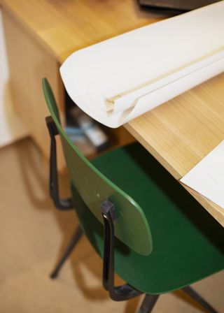 workspace detail with dark wood joinery and green chair