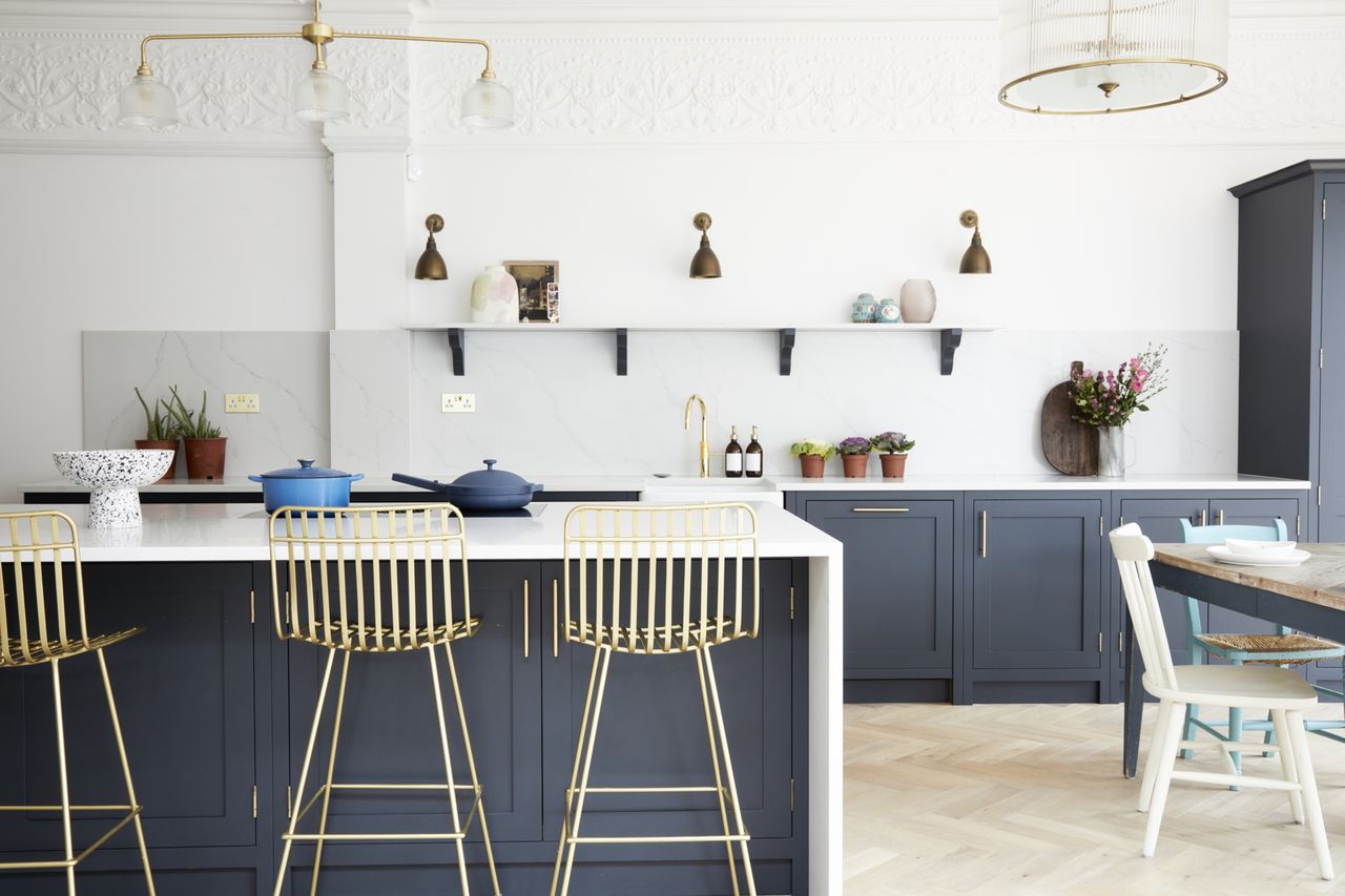 refacing vs replacing kitchen cabinets: white kitchen with blue kitchen cabinets by Olive &amp; Barr