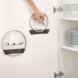 kitchen storage with pan lid holders in cupboard
