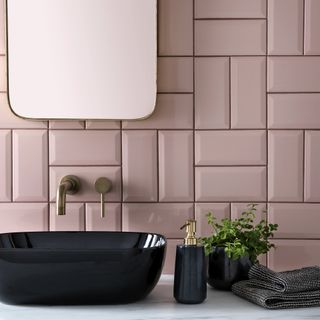 bathroom with pink ceramic tiled wall