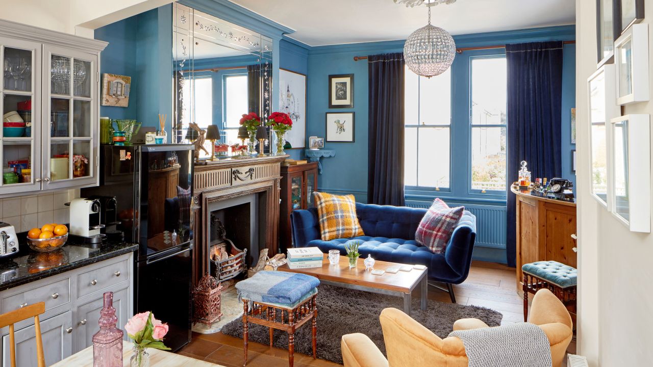 Living room with blue walls and sofa, yellow armchair, fireplace 