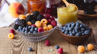 Bowls of fresh fruit, including berries and jam, something for those who are eating the same thing every day