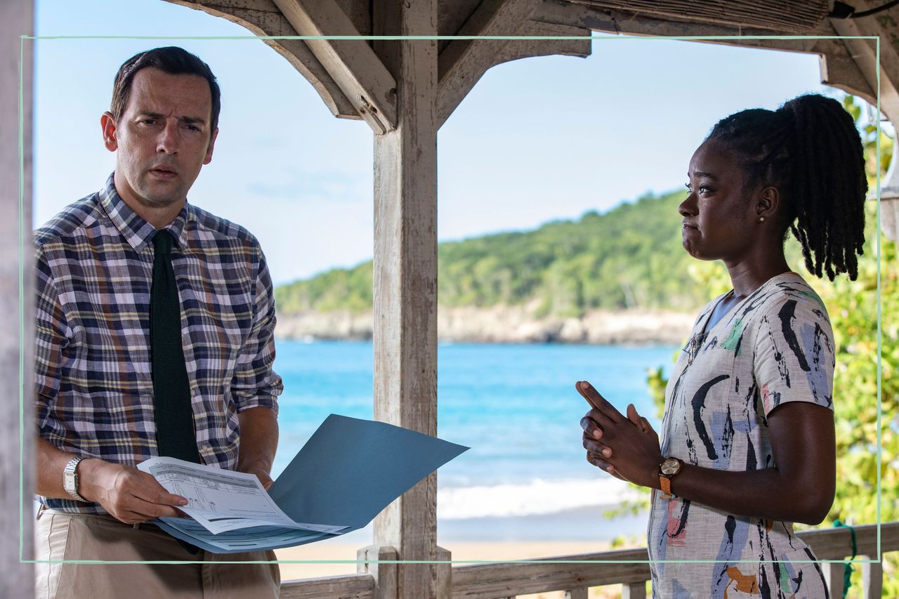 a still of Ralf Little in Death in Paradise, starring alongside Shantol Jackson as Naomi Thomas