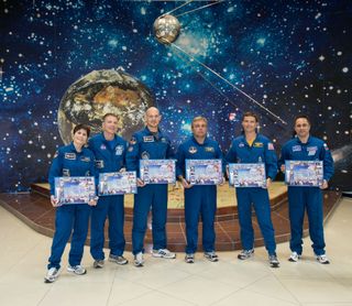 Expedition 40/41 Crew Displays Montages of Space Memorabilia Photos