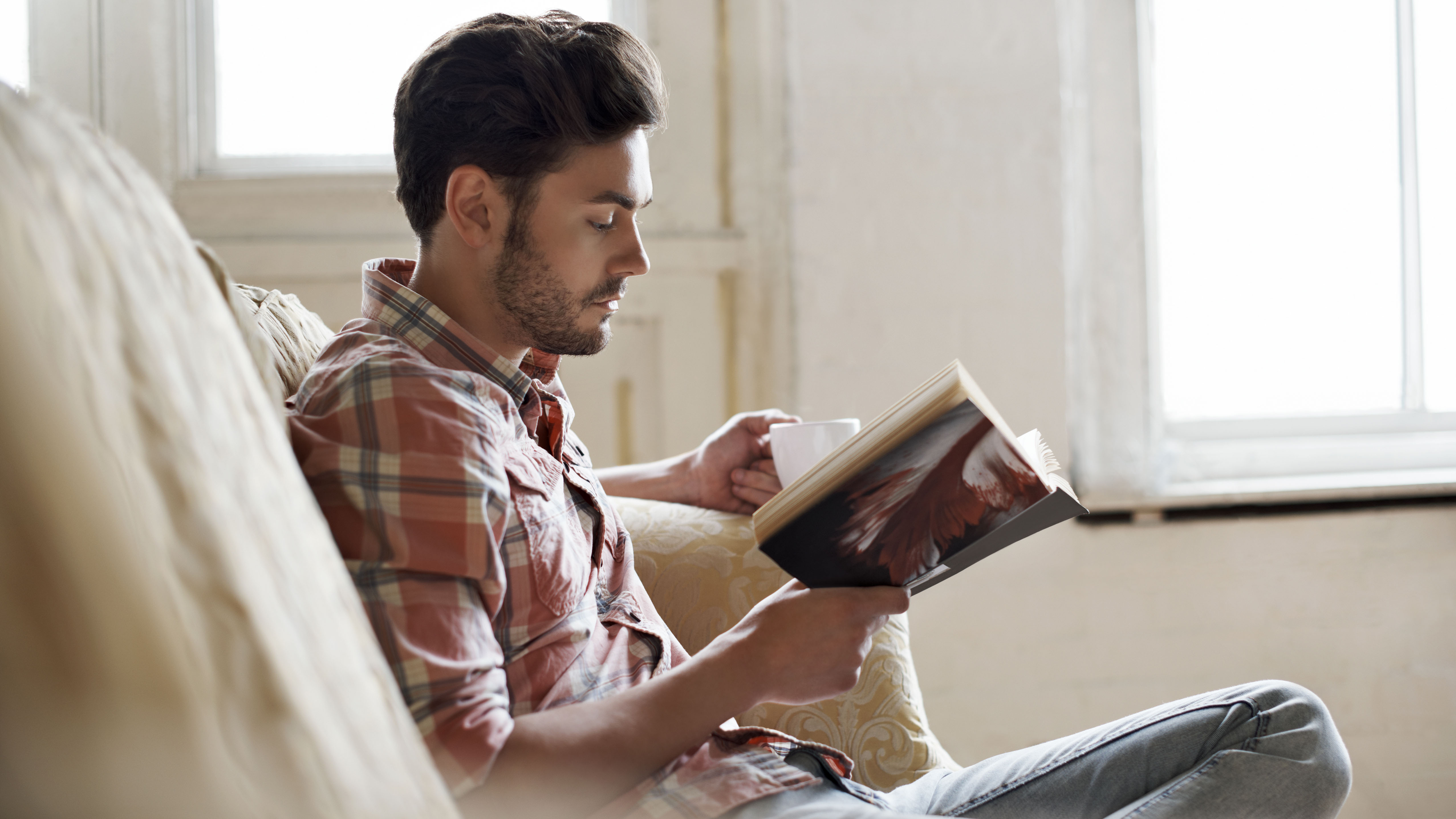 Man relaxing and reading book