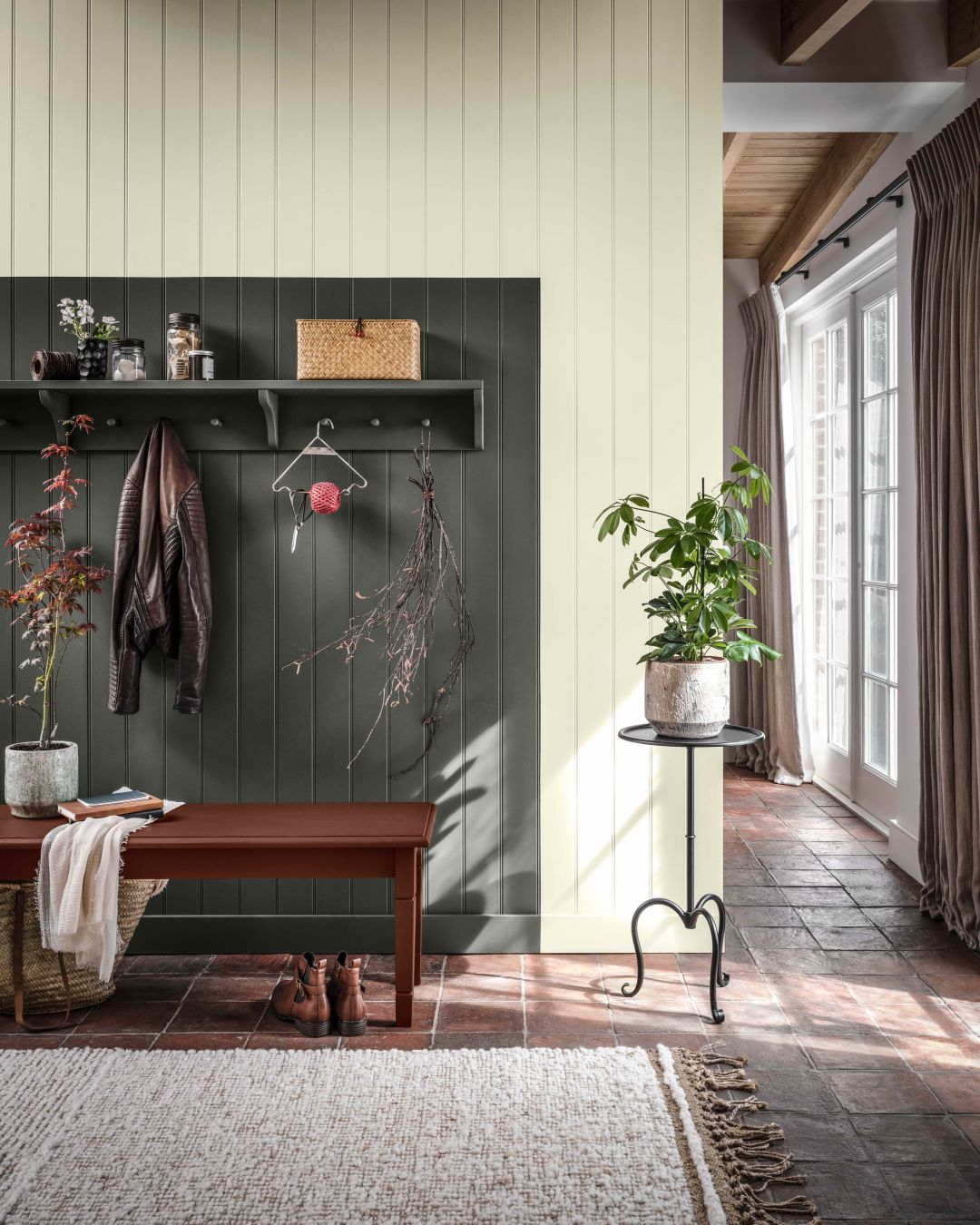 hallway with wall panelling, wooden bench, and houseplants