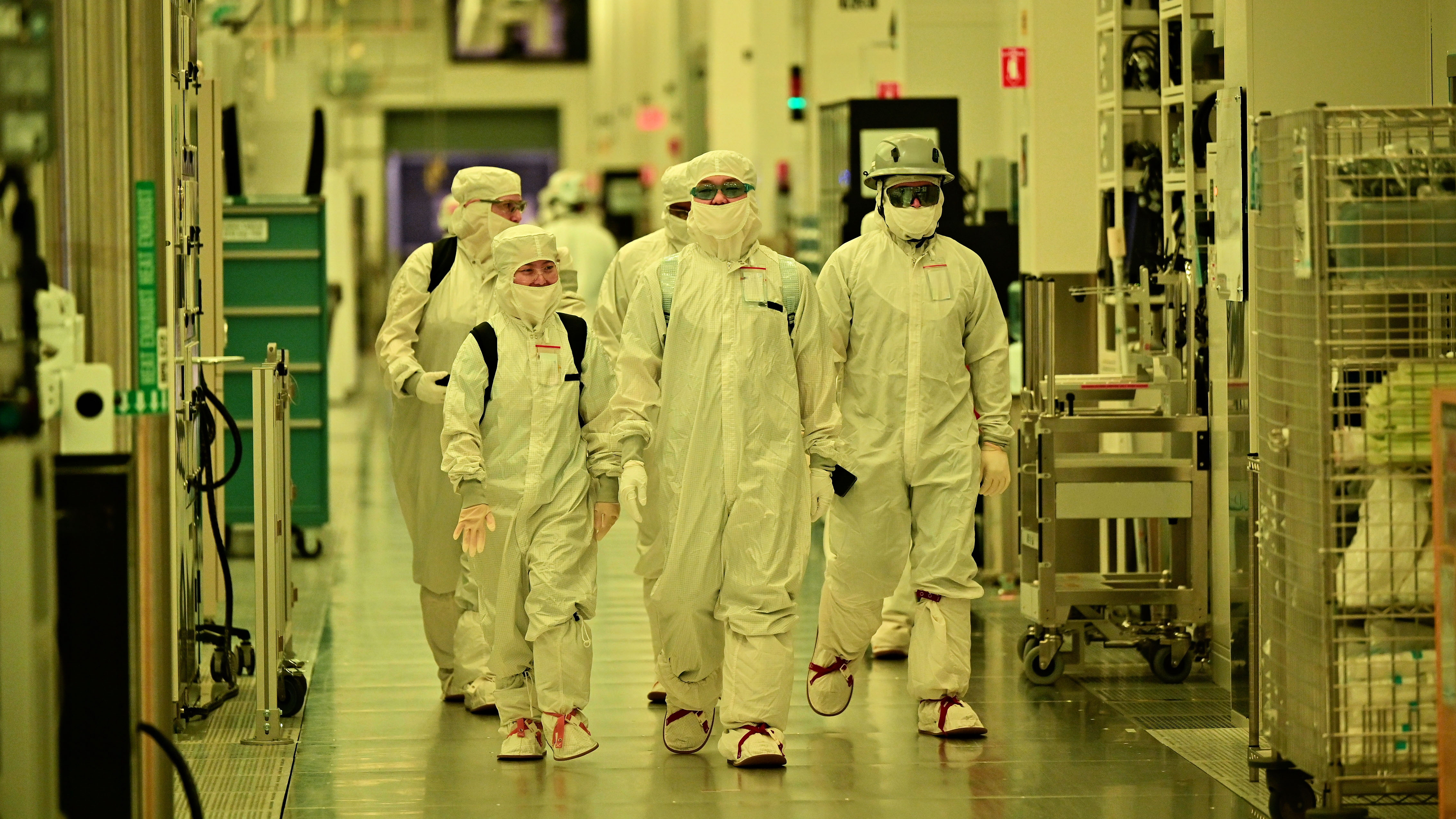 Intel workers walking through the Intel Fab 52 facility
