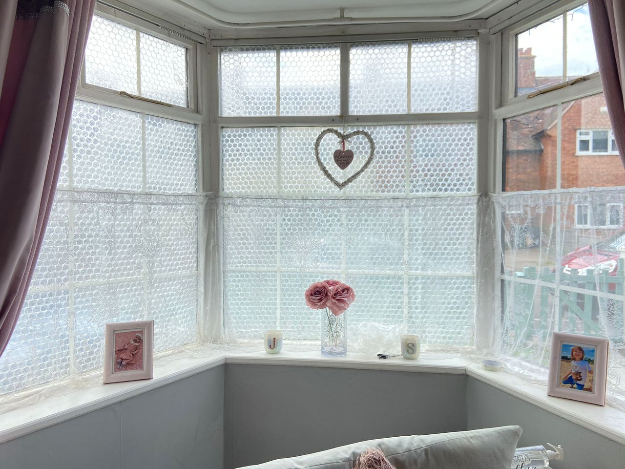 A bay window with bubble wrap added to the window panes