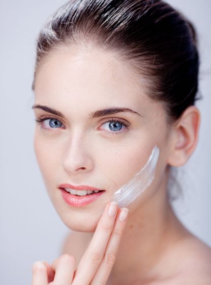 Woman using face cream
