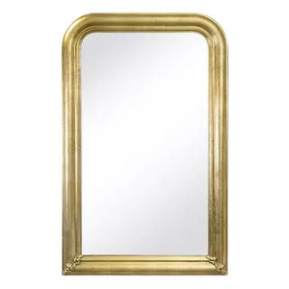 Tall gold Regina Andrew mirror with rounded top edges and ornate leaves in bottom corners