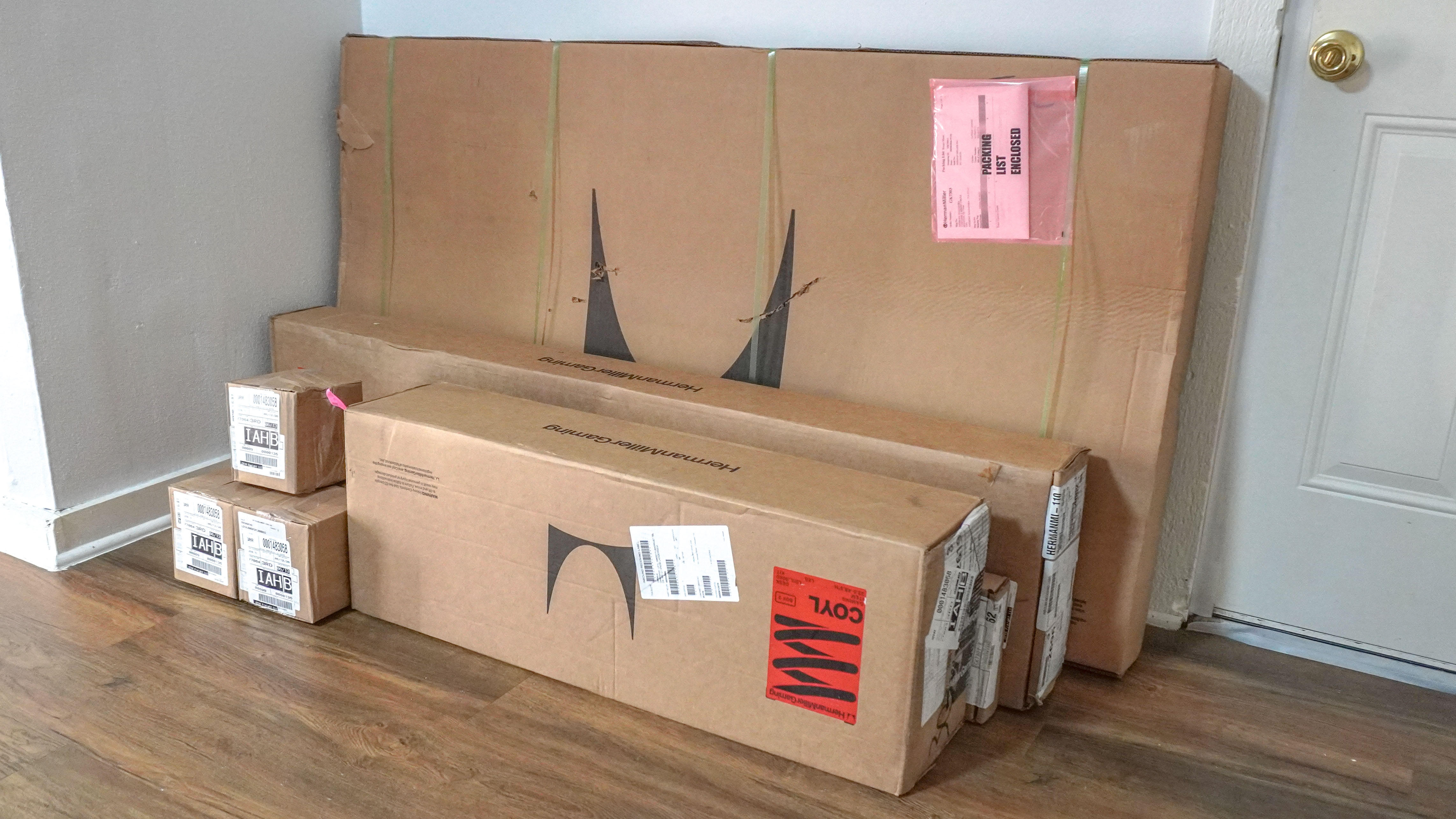 The multiple boxes the Herman Miller Coyl Gaming Desk arrives in stacked against a wall