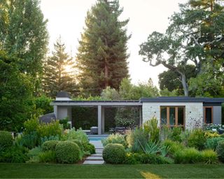 California backyard landscaping ideas showing a pool with lush xeriscaping