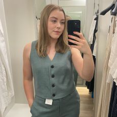 Woman in dressing room wearing linen waistcoat and linen trousers