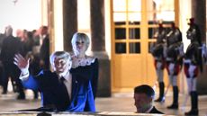 President Donald Trump waves outside Versailles palace near Paris