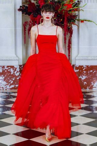Model in red Carolina Herrera gown