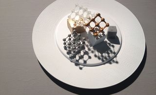 A white plate, with 3D printed cubes on it.