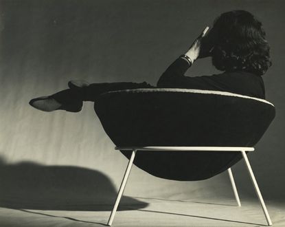 Lina Bo Bardi reclines in the semi-spherical 'Bowl Chair'