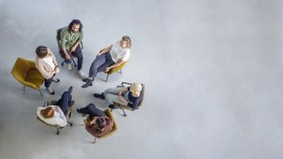 An overhead shot of a group of smart-dressed people having a meeting