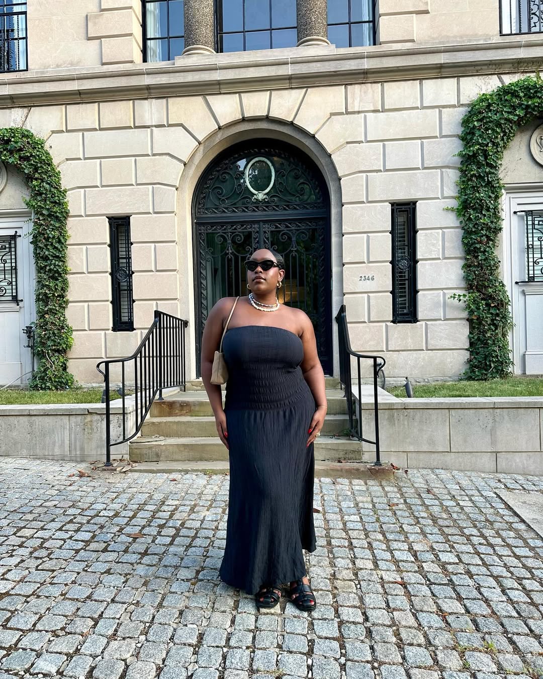 woman wearing black maxi dress and sunglasses