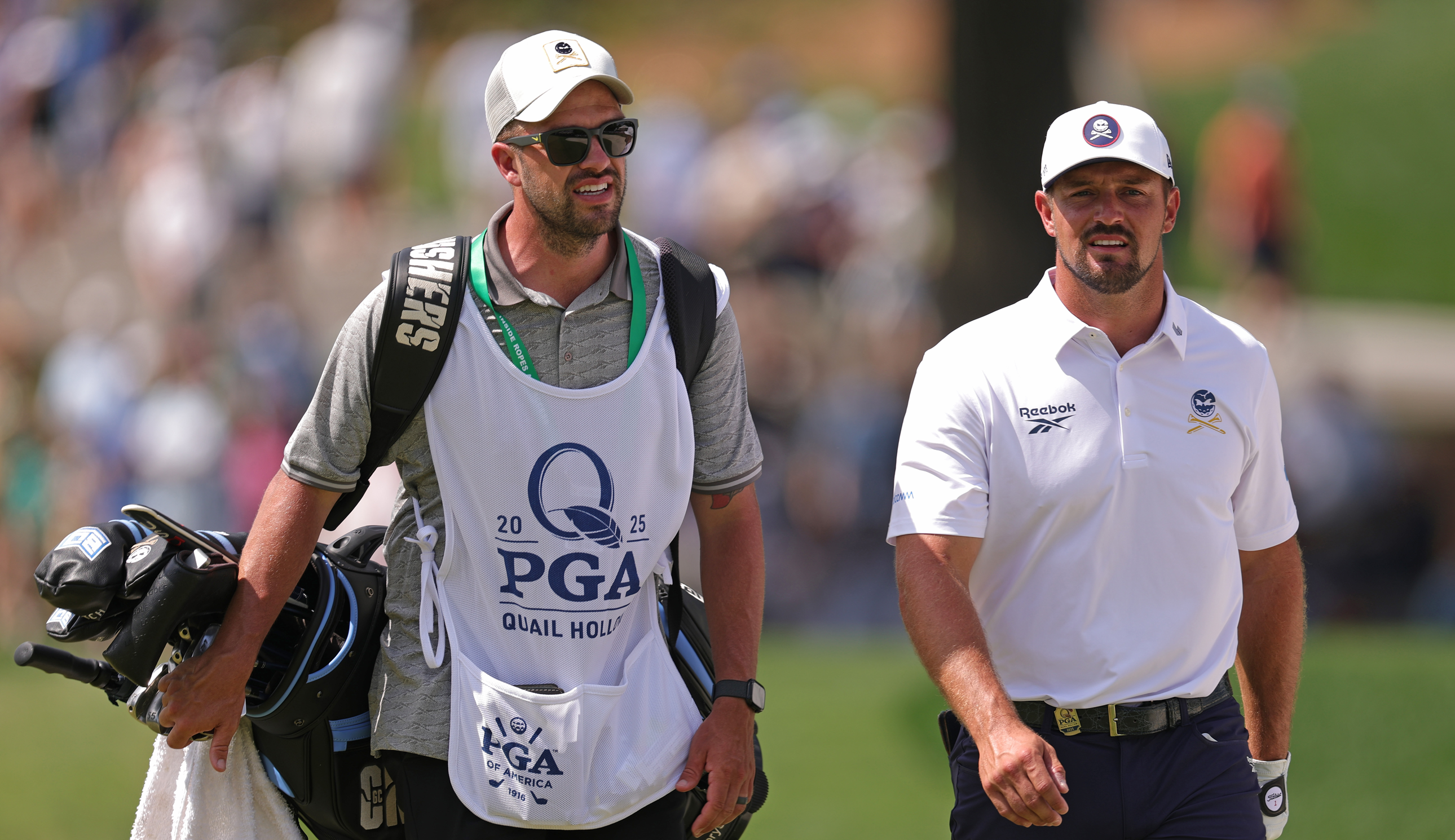 Bryson DeChambeau and his caddie walk down the fairway