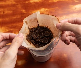 Used coffee ground left in a coffee dripper. Coffee grounds can be used as a fertilizer.