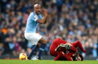 Mohamed Salah feels the effect of a tackle from Vincent Kompany