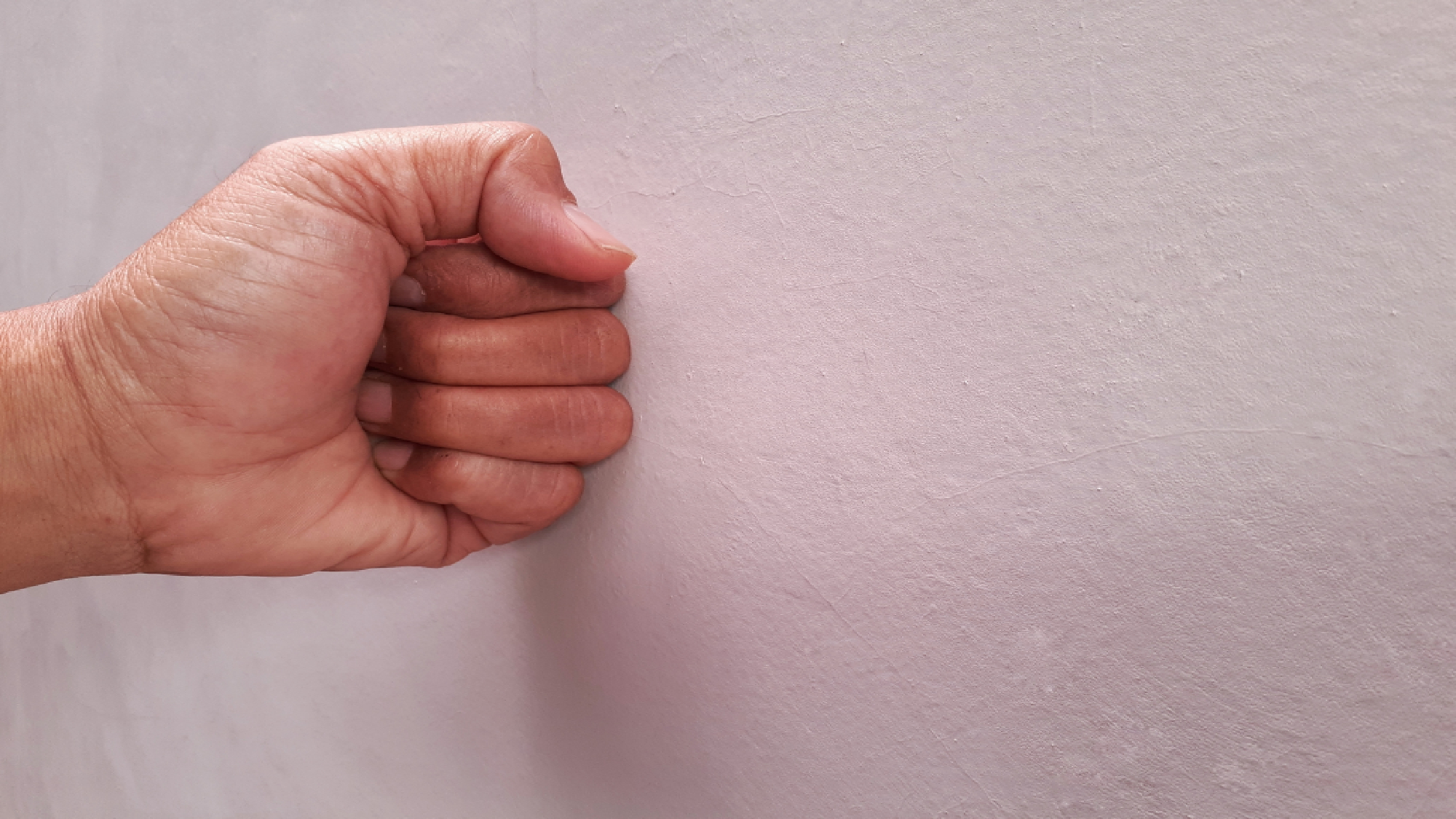 Knocking on wall to check for studs