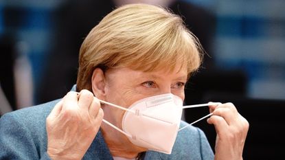 Angela Merkel puts on a FFP2 face mask