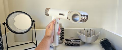 Shark SpeedStyle hairdryer being held in front of mirror with RapidGloss Finisher attachment connected