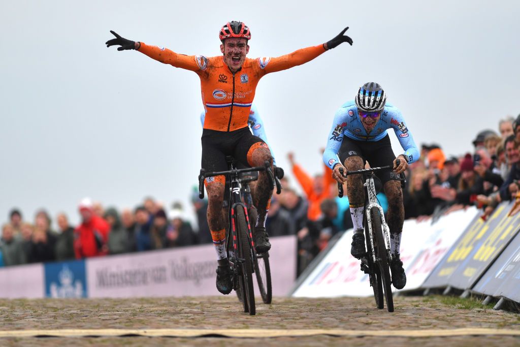 COL DU VAM DRENTHE NETHERLANDS NOVEMBER 06 Ryan Kamp of Netherlands celebrates at finish line as race winner ahead of Niels Vandeputte of Belgium during the 19th UEC European Cyclocross Championships 2021 Mens U23 EuroCross21 UECcycling on November 06 2021 in Col du Vam Drenthe Netherlands Photo by Luc ClaessenGetty Images