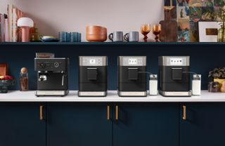 Four KitchenAid coffee machines on a kitchen countertop