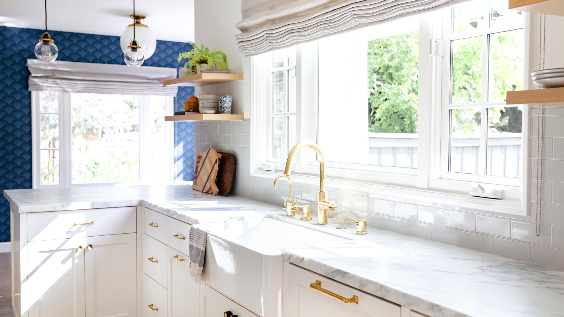 picture of neutral kitchen with marble tops and gold fixtures