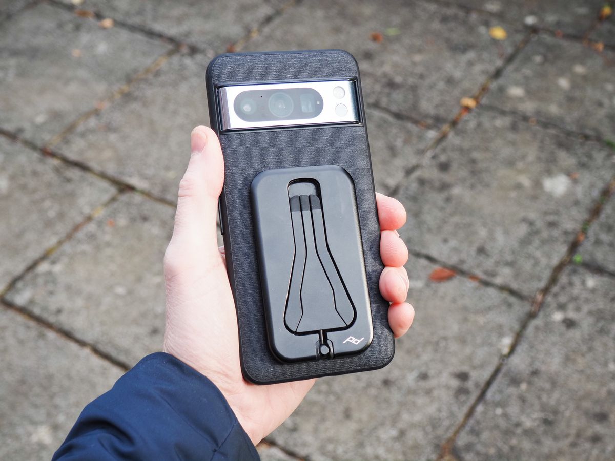 Peak Design Mobile Tripod folded away attached to a Pixel phone with Peak Design's dedicated case, in user's hand