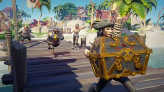 A pirate carries a giant chest of treasure followed by four of their crewmates down the boardwalk inSea of Thieves