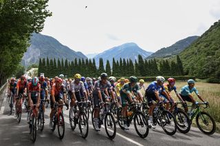 The pack of riders (peloton) cycles at the start of the 5th stage of the 111th edition of the Tour de France cycling race, 177,5 km between Saint-Jean-de-Maurienne and Saint-Vulbas, on July 3, 2024. (Photo by Anne-Christine POUJOULAT / AFP) (Photo by ANNE-CHRISTINE POUJOULAT/AFP via Getty Images)