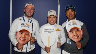 Inbee Park of South Korea poses with her caddie Brad Beecher (L) and her husband and coach Gi Hyeob Nam after she gained entry in the LPGA Hall of Fame