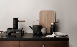 Black coffee brewing set on a black counter