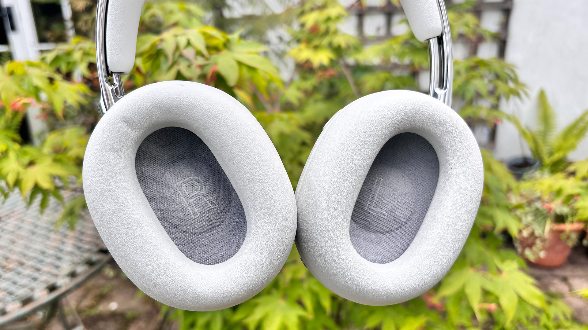 Sony 1000X The Collexion wireless headphones in front of garden plant with inner earcups shown