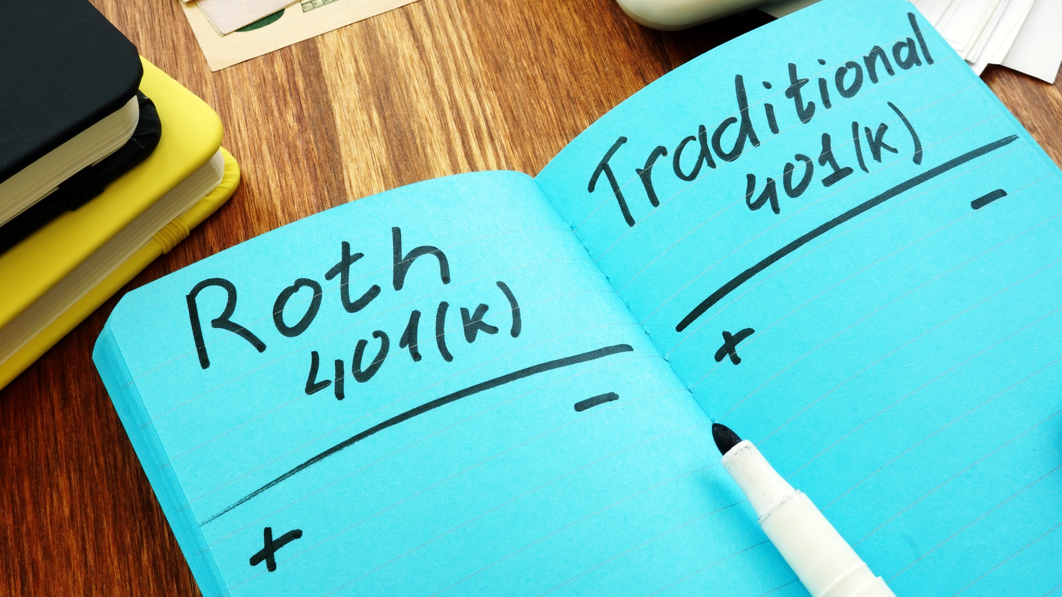 Roth 401k vs traditional. Comparison of retirement plans in a notebook.