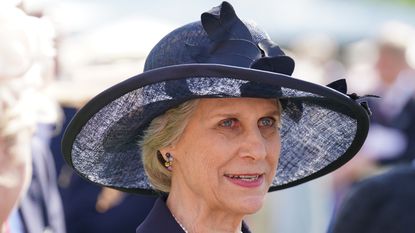 Duchess of Gloucester's navy blue shirt dress worn as she attends the Royal Kennel Club Garden Party