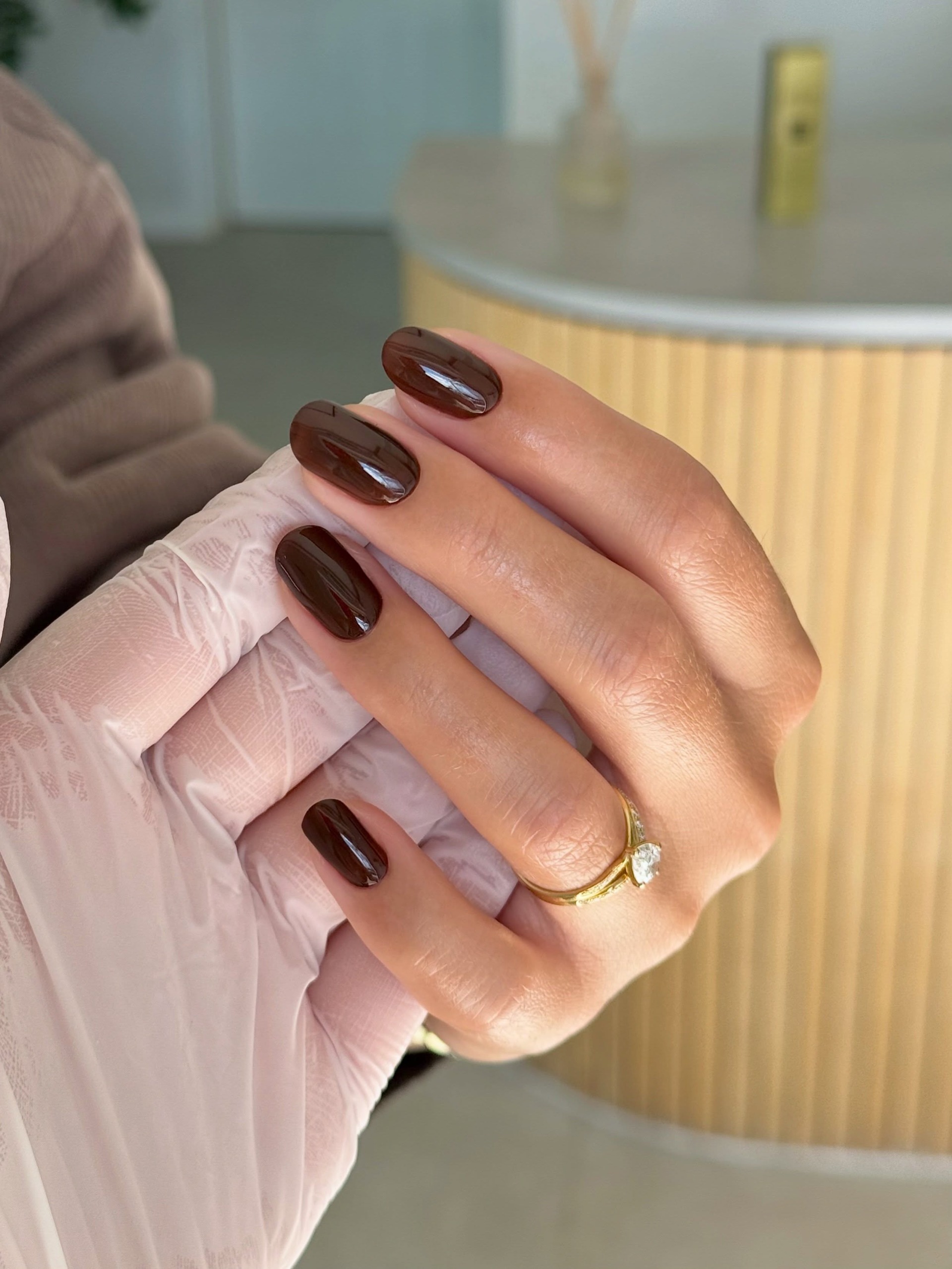 espresso brown manicure with a gold diamond ring