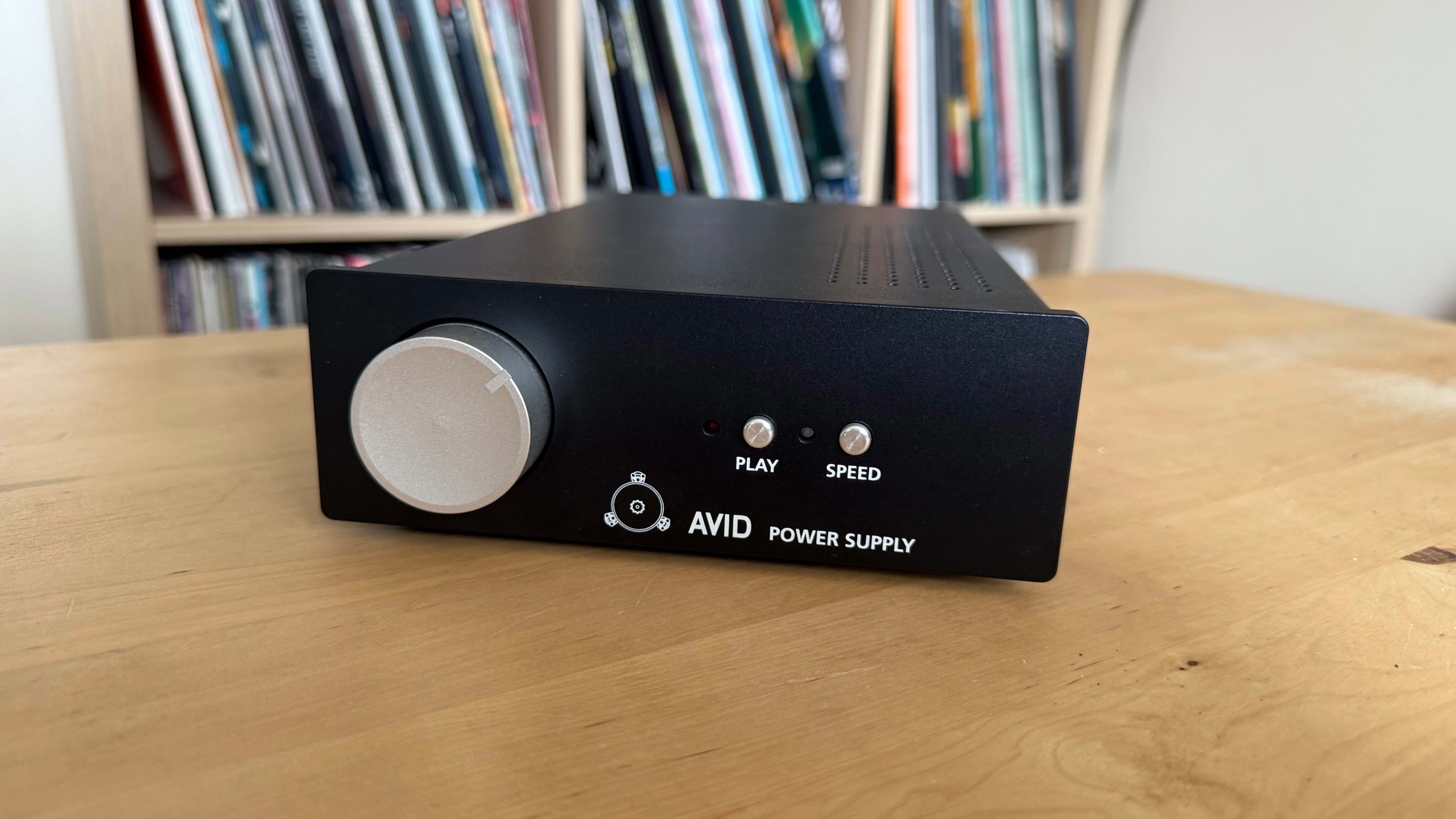 Avid Ingenium Plug&Play turntable power supply on a wooden surface