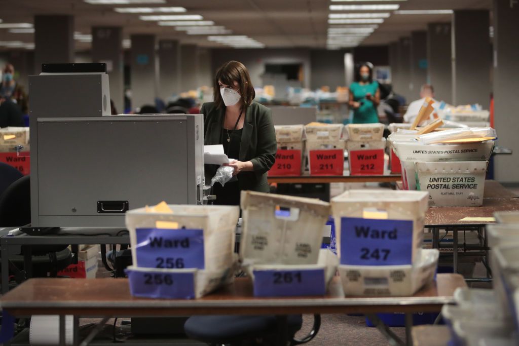 Claire Woodall-Vogg collects absentee ballot information in Milwaukee.