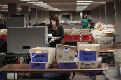 Claire Woodall-Vogg collects absentee ballot information in Milwaukee.