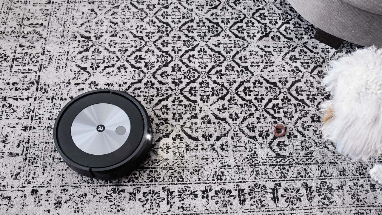iRobot Roomba j7+ on carpet with light on