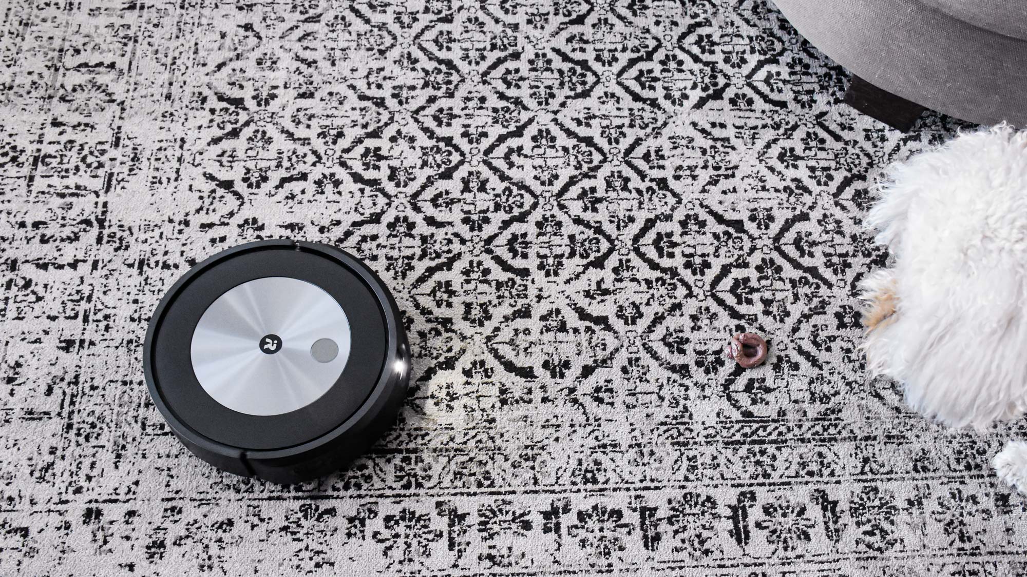 iRobot Roomba j7+ on carpet with light on