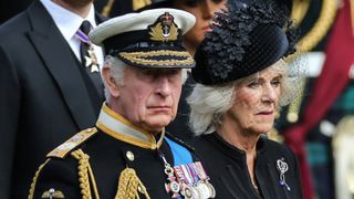 Britain's King Charles III and Britain's Camilla, Queen Consort look at members of the Bearer Party transferring the coffin of Queen Elizabeth II